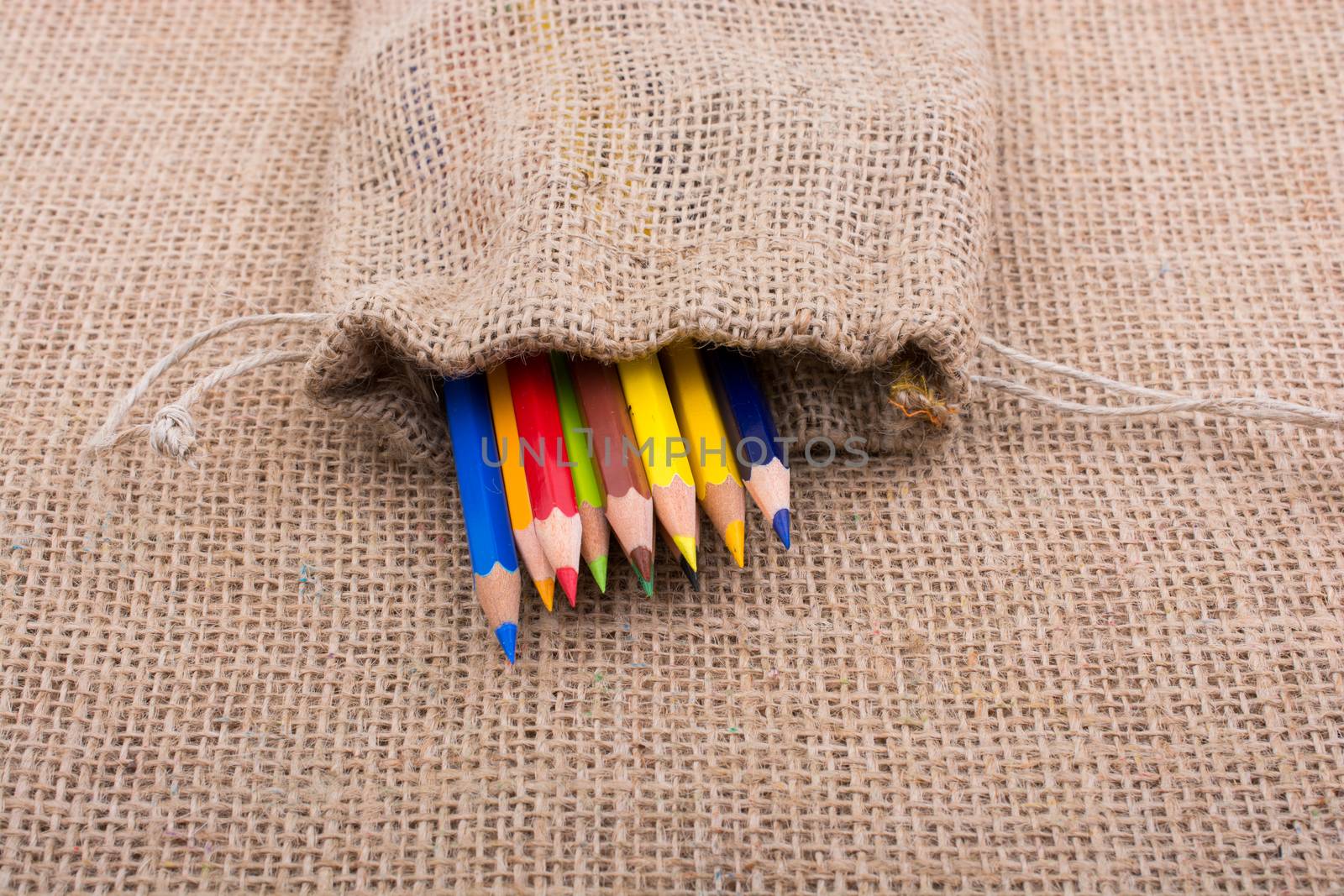 Color Pencils in a linen sack on canvas