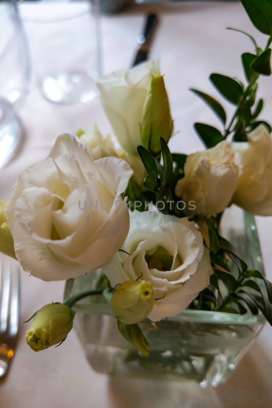 White pink and yellow roses flowers on table for a wedding. by kip02kas