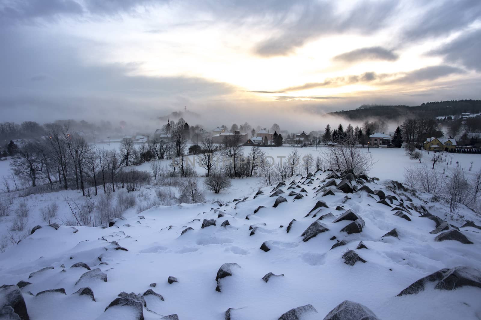 Winter basalt formation Panska skala, close Kamenicky Senov in Czech Republic. Exposed basalt poles of burned out volcano.