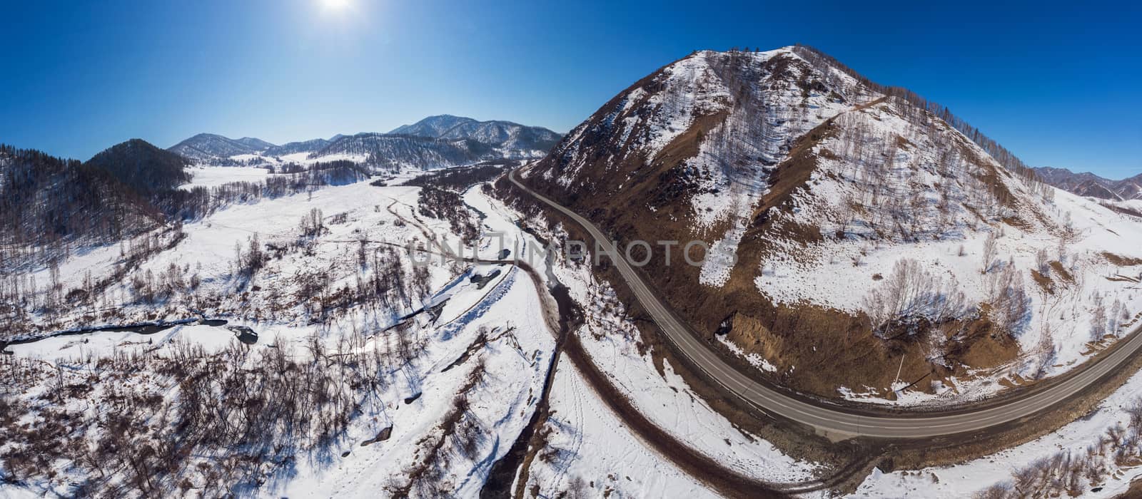 Aerial view of a road in winter landscape of Altai mountains