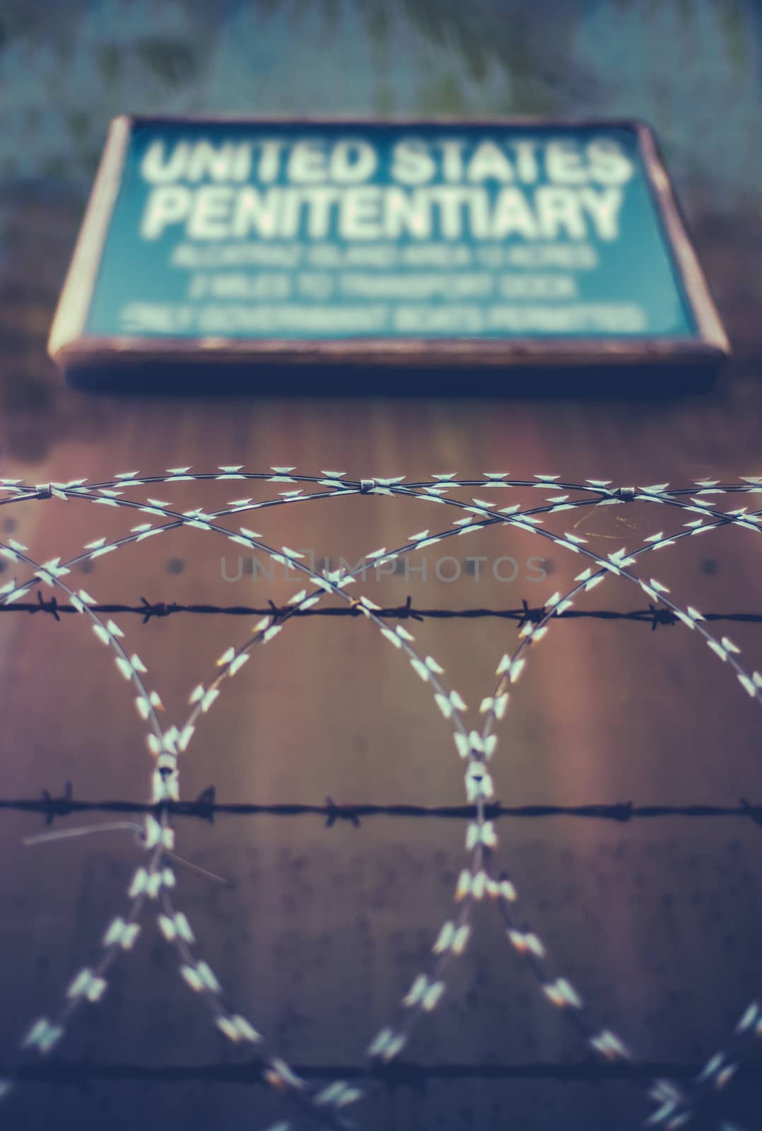 A Sign For A High Security United States Penitentiary Or Prison Behind Razor And Barbed Wire