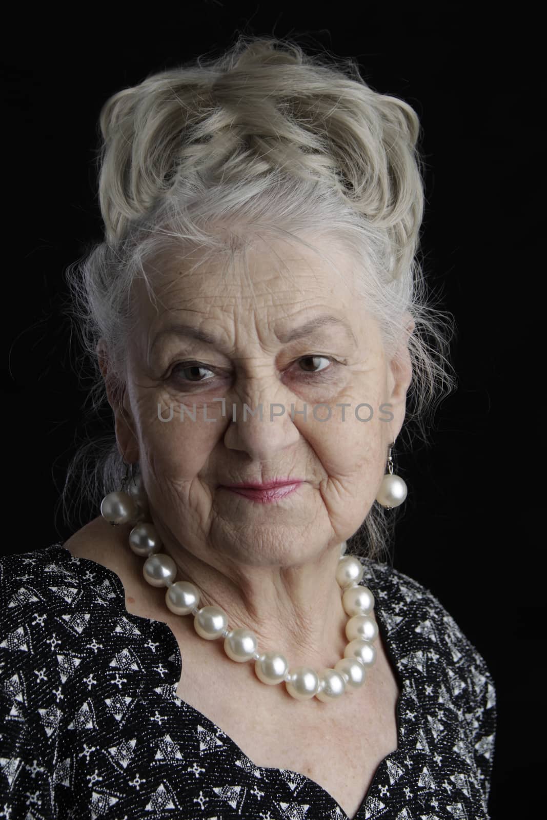 A very old woman. An eighty-year-old woman. Studio portrait of an old woman