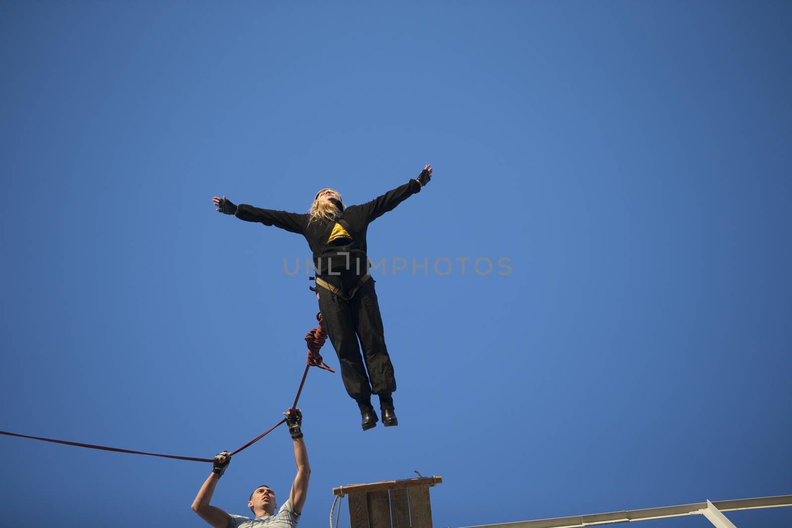 Elderly woman jumping from a bridge by Sviatlana