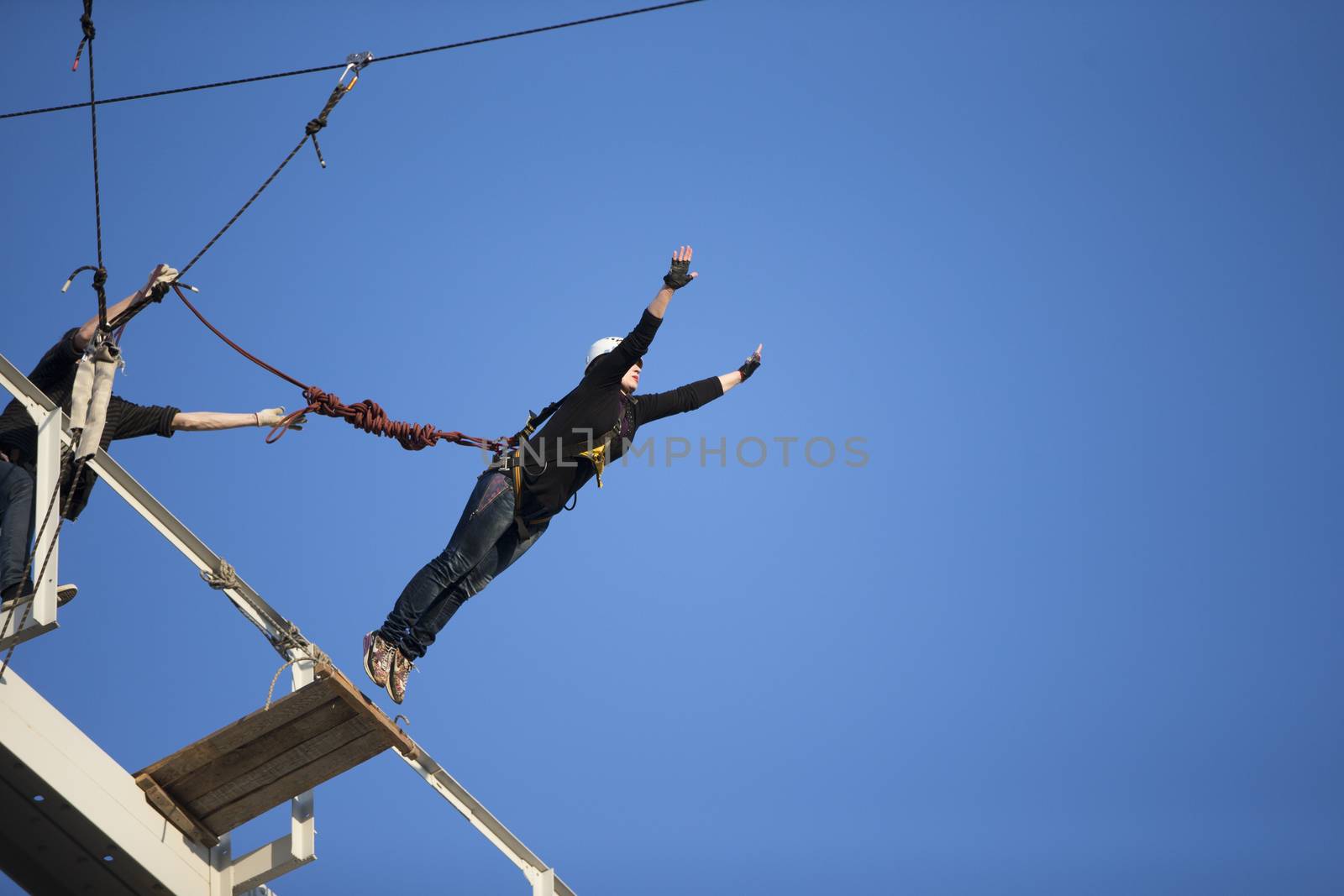 Elderly woman jumping from a bridgeJumping from the bridge with a rope. RoupeJumping