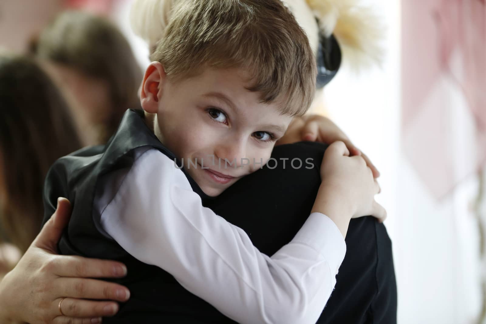 The child hugs mom. The boy in the arms of the mother. by Sviatlana