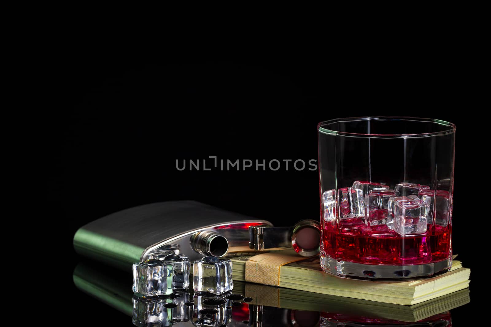 Stainless steel flask liquor alcohol and ice on table with glass by SaitanSainam