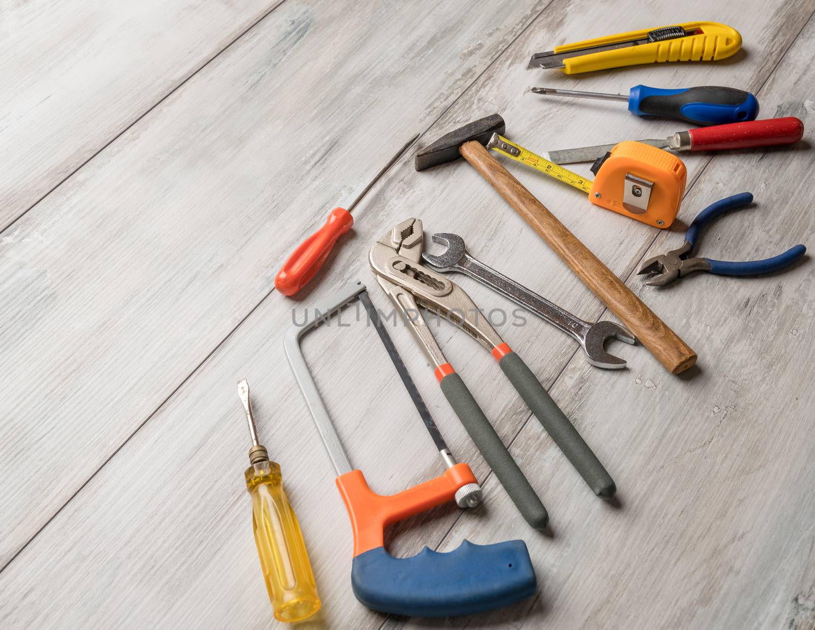 Screwdriver,hammer,tape measure and other tool for construction tools on gray wooden background with copy space,industry engineer tool concept.still-life.