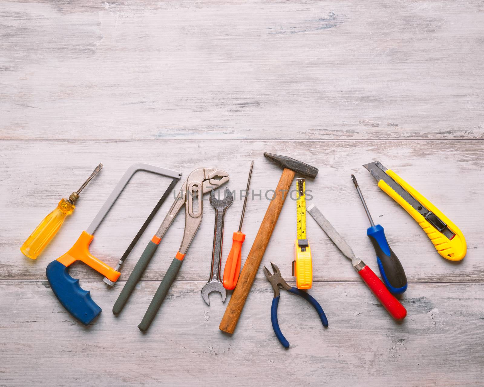 Screwdriver,hammer,tape measure and other tool for construction tools on gray wooden background with copy space,industry engineer tool concept.still-life.