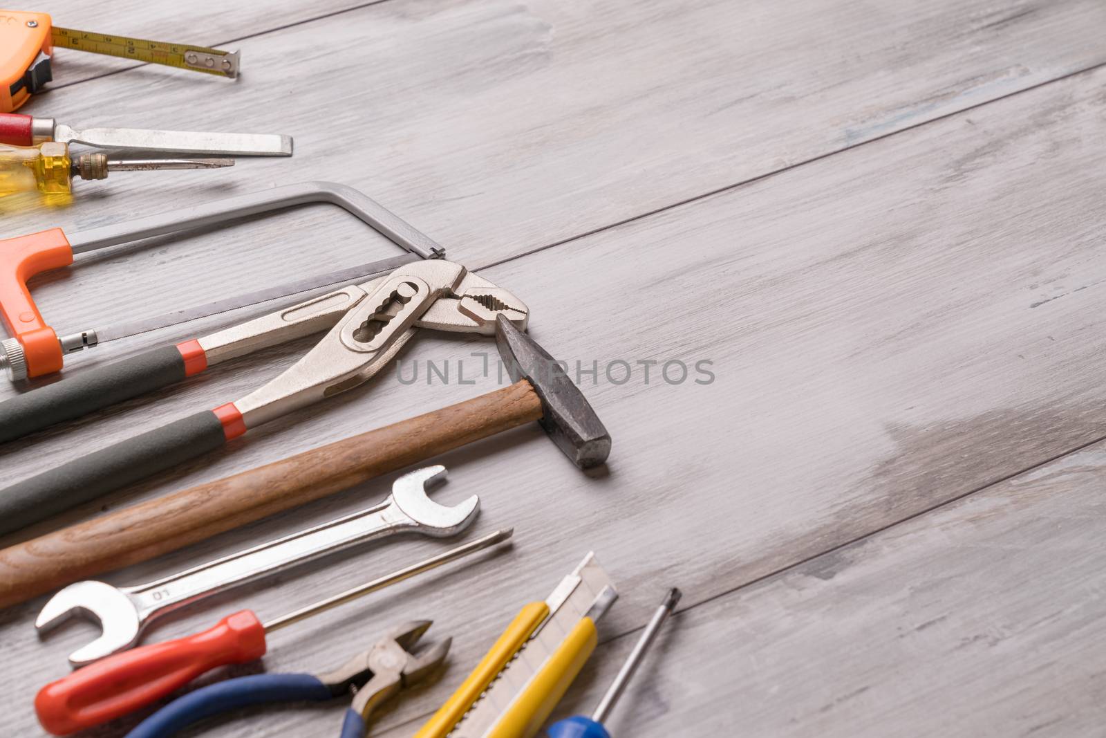 Screwdriver,hammer,tape measure and other tool for construction tools on gray wooden background with copy space,industry engineer tool concept.still-life.