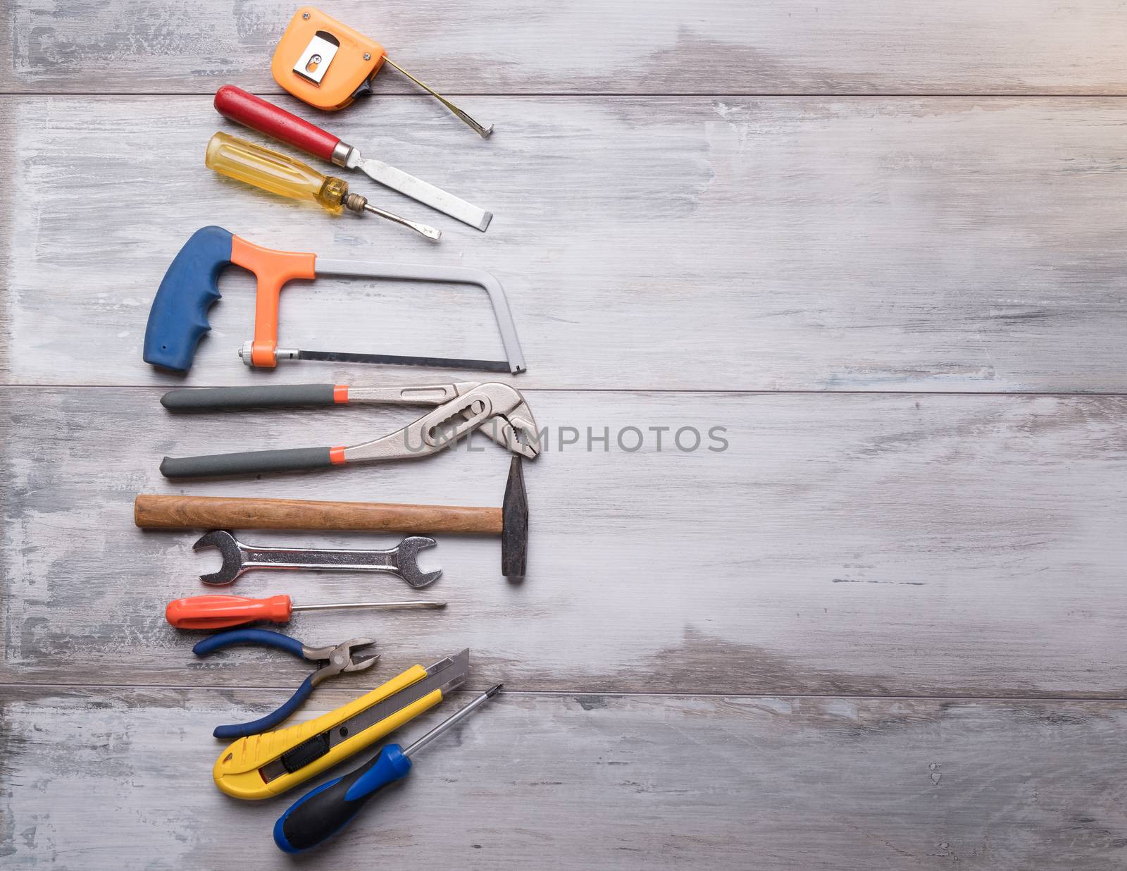 Screwdriver,hammer,tape measure and other tool for construction tools on gray wooden background with copy space,industry engineer tool concept.still-life.