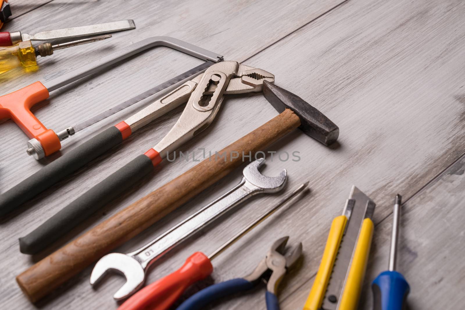 Screwdriver,hammer,tape measure and other tool for construction tools on gray wooden background,industry engineer tool concept.still-life.