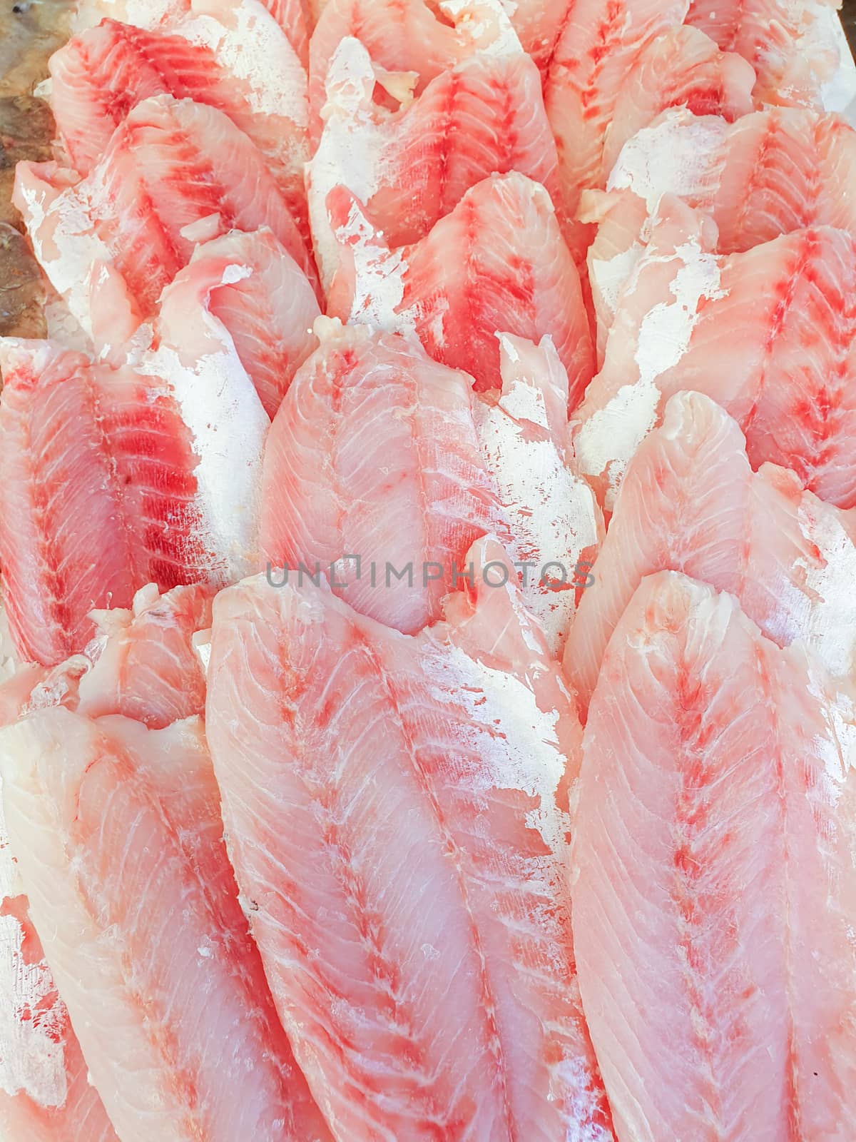 African perch fillet on ice for sale, Fish local market stall with fresh water fish,view from top.