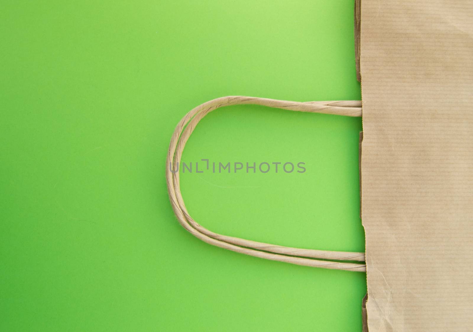 Concept of zero waste, reusable paper bag for shopping, free plastic, green background, top view by claire_lucia