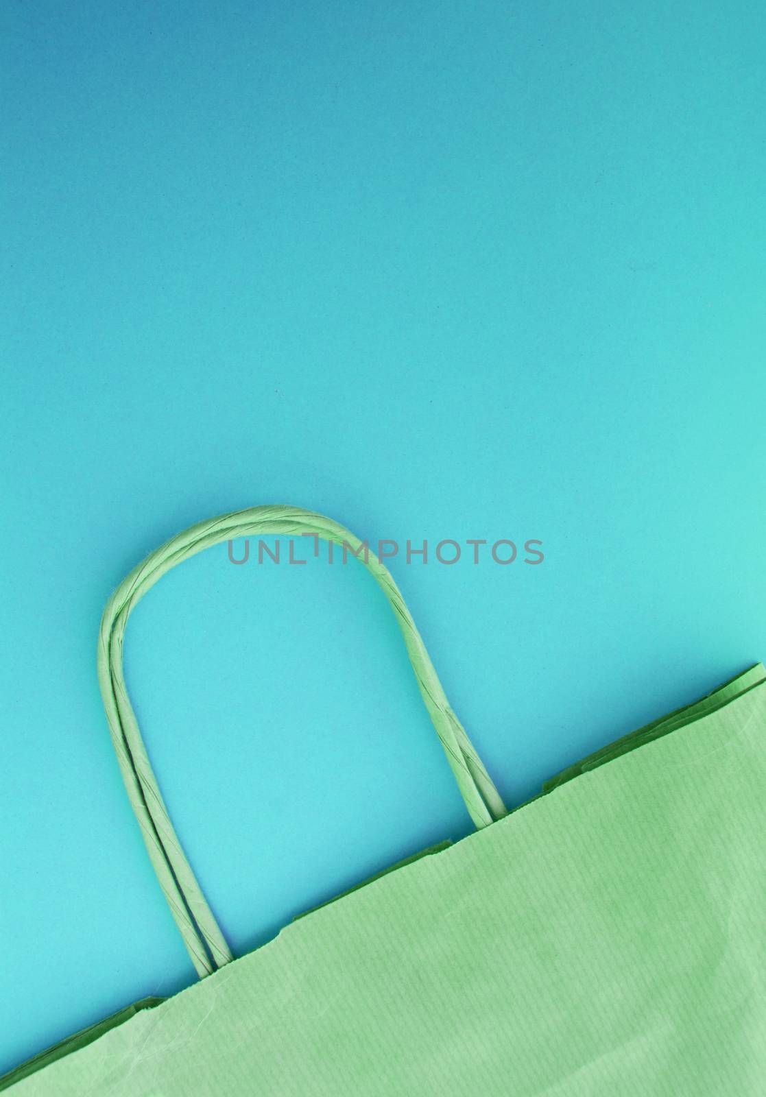 The concept of zero waste life. Paper reusable shopping bag, without plastic, top view, blue background. vertical photo
