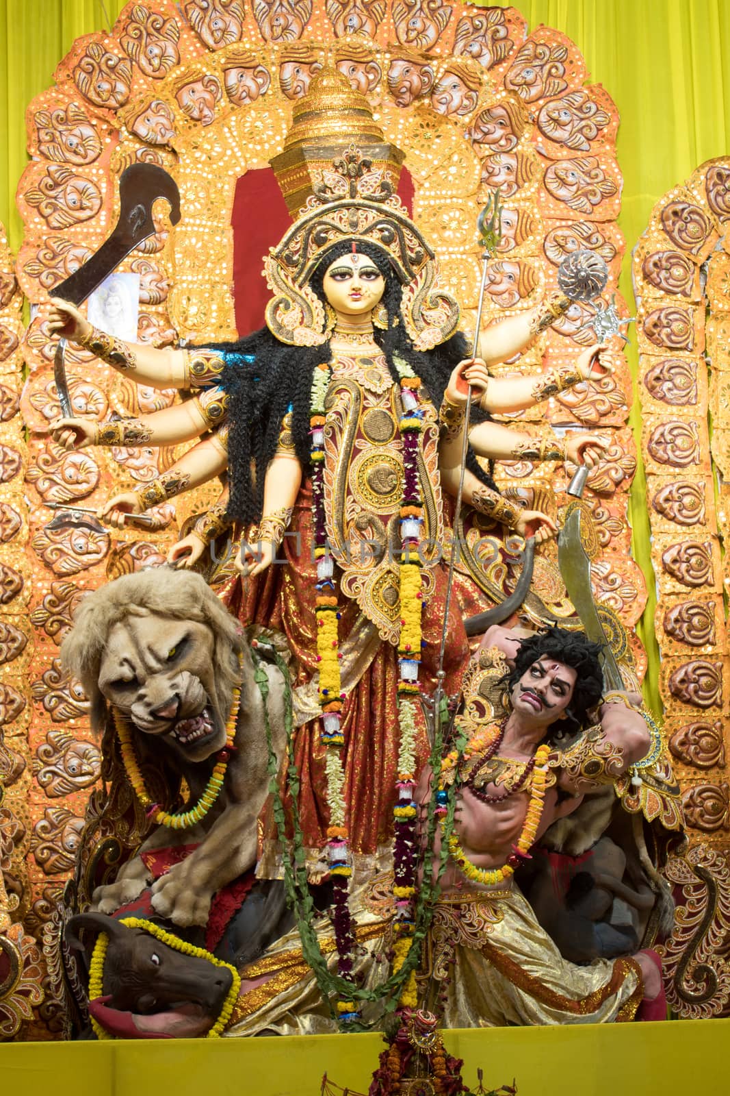 KOLKATA, INDIA - OCTOBER 7, 2016: Potrait Of Goddess Durga idol at a South Kolkata famous Durga puja temple (pandal) on "Maha Ashtami". by sudiptabhowmick