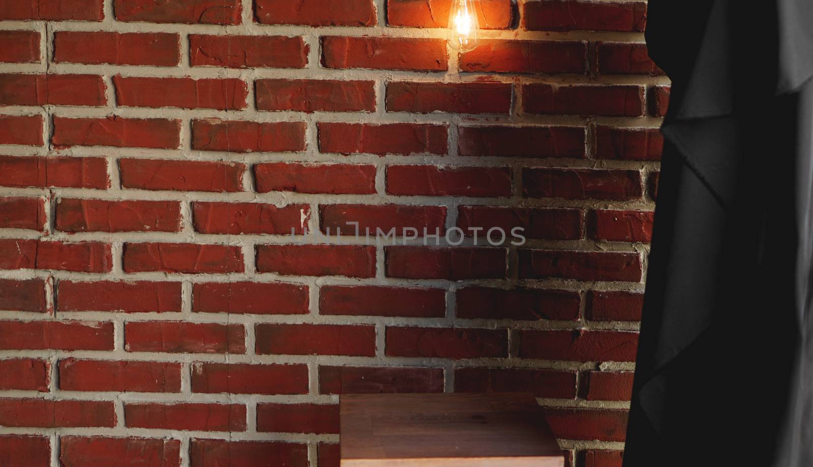 Decorative antique edison style light tungsten bulbs against brick wall by natali_brill