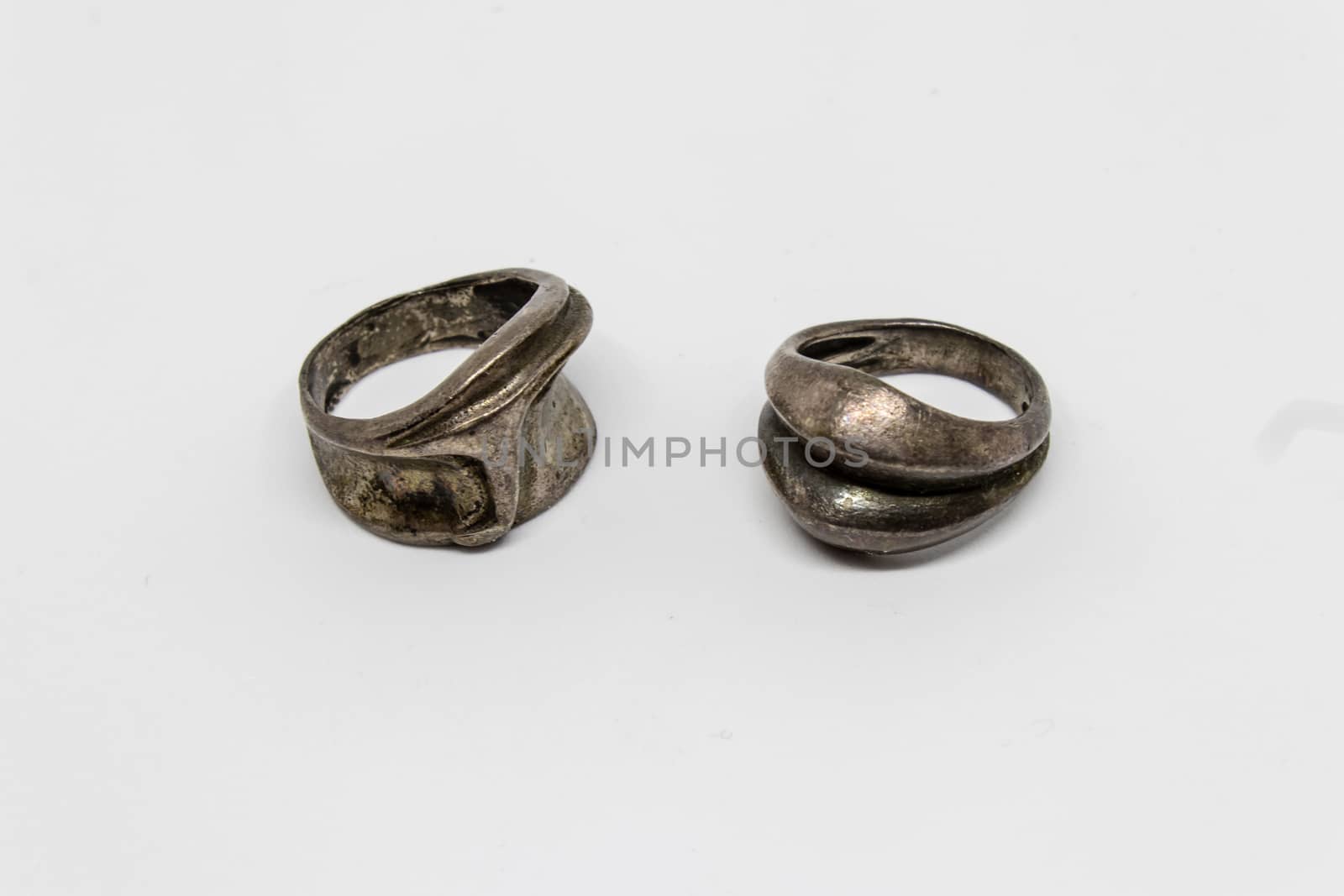 antique strange shaped silver rings with white background.