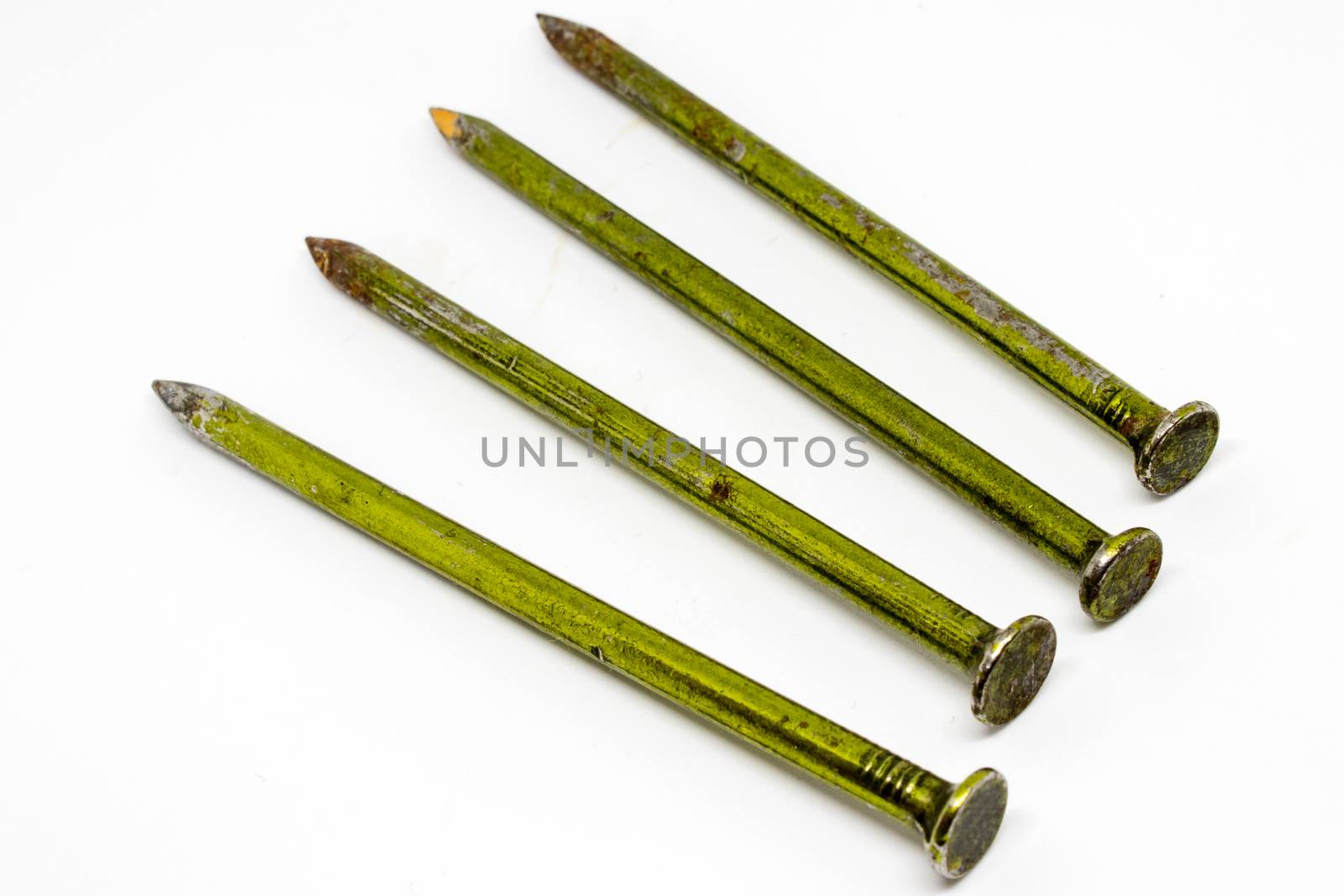 four old metal rusty nails closeup with white background. detailed product shoot.
