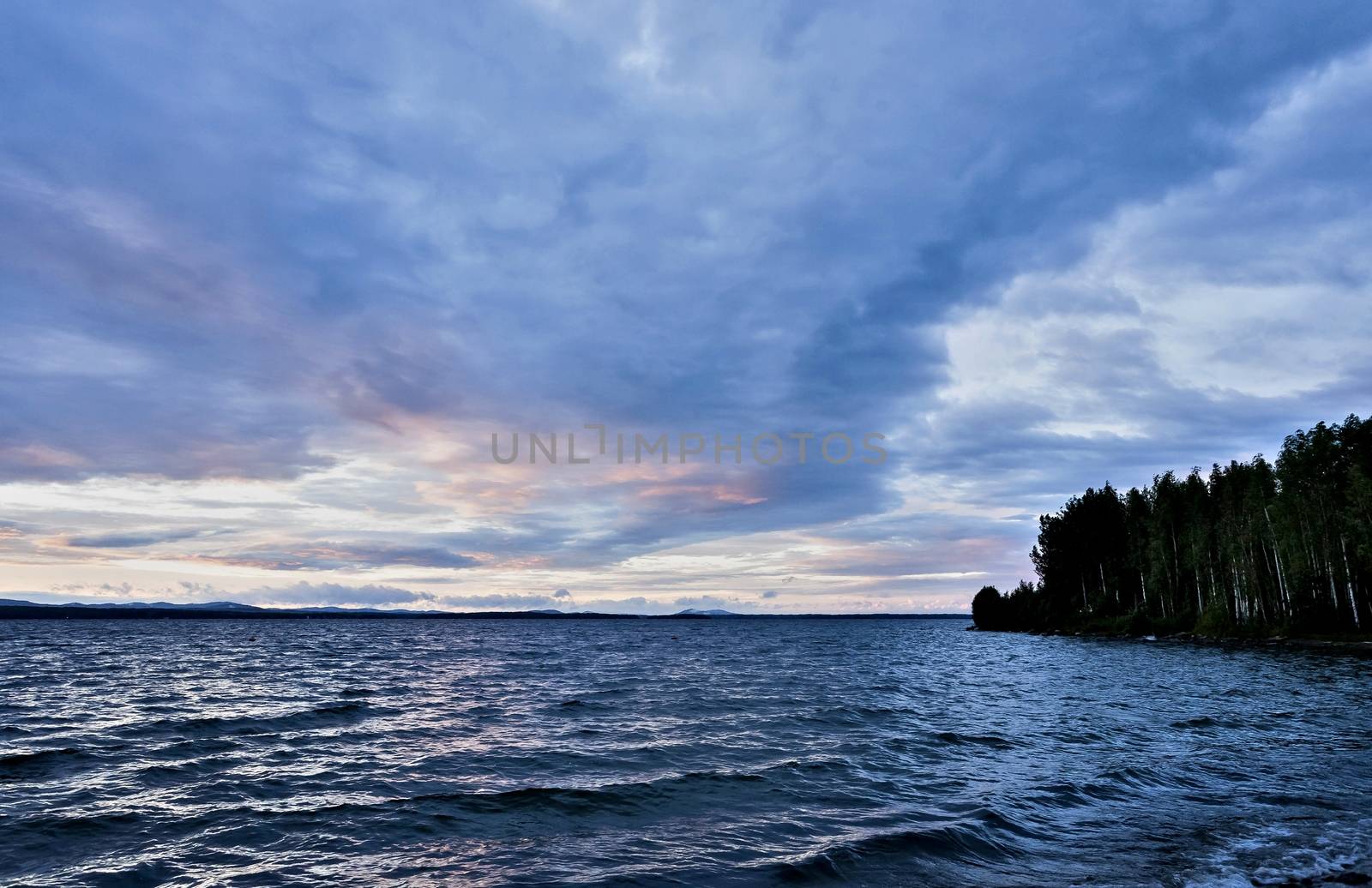 dark blue evening cloudy sky over the lake, wind, waves, watercolor sky, heavy Shine of water