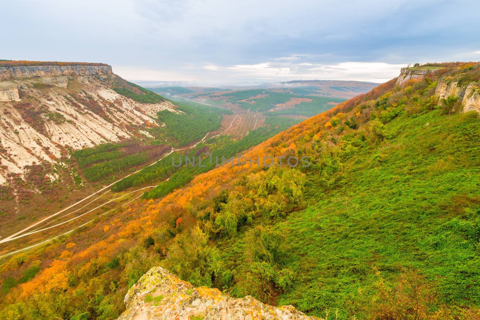 Beautiful autumn mountain landscape - view of the valley on a cloudy day and a table mountain