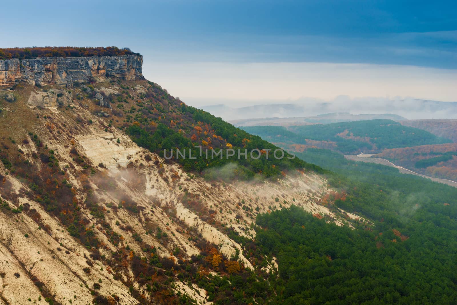 Beautiful misty valley in the mountains on a cloudy autumn day by kosmsos111