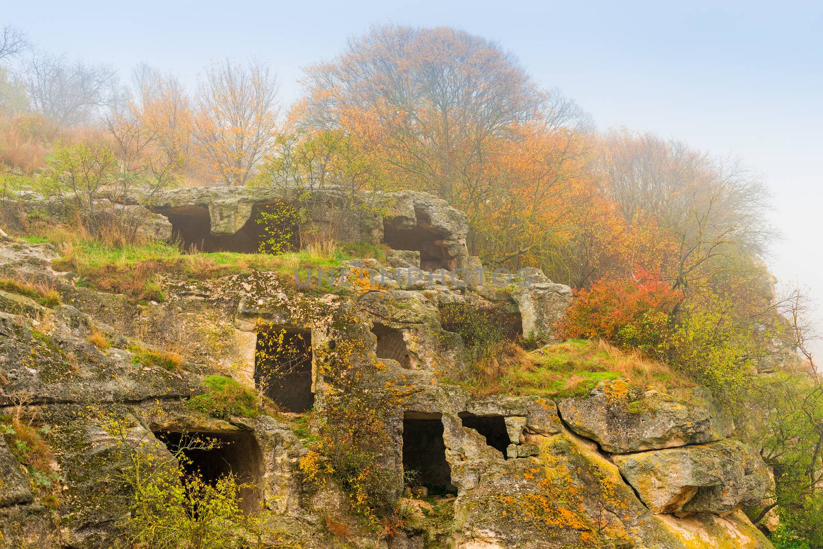 rooms of the cave city of Chufut-Kale, autumn foggy day, Crimea, Russia