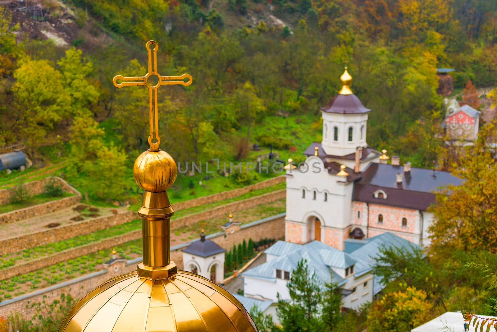 Golden dome of the Orthodox Russian church with a cross, close-up