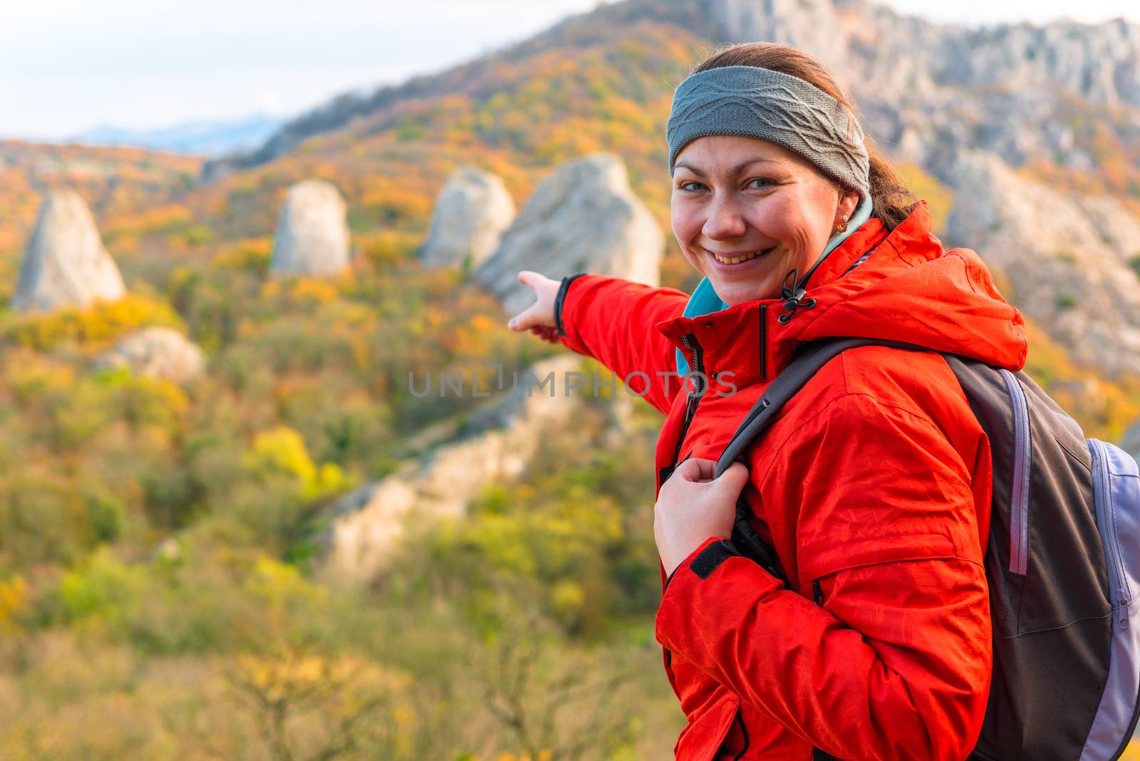 A traveler is pointing at the cliffs, a portrait in the autumn m by kosmsos111