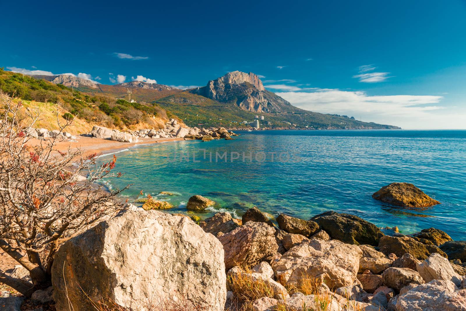 Rocky seashore, mountain and seascape on a sunny day