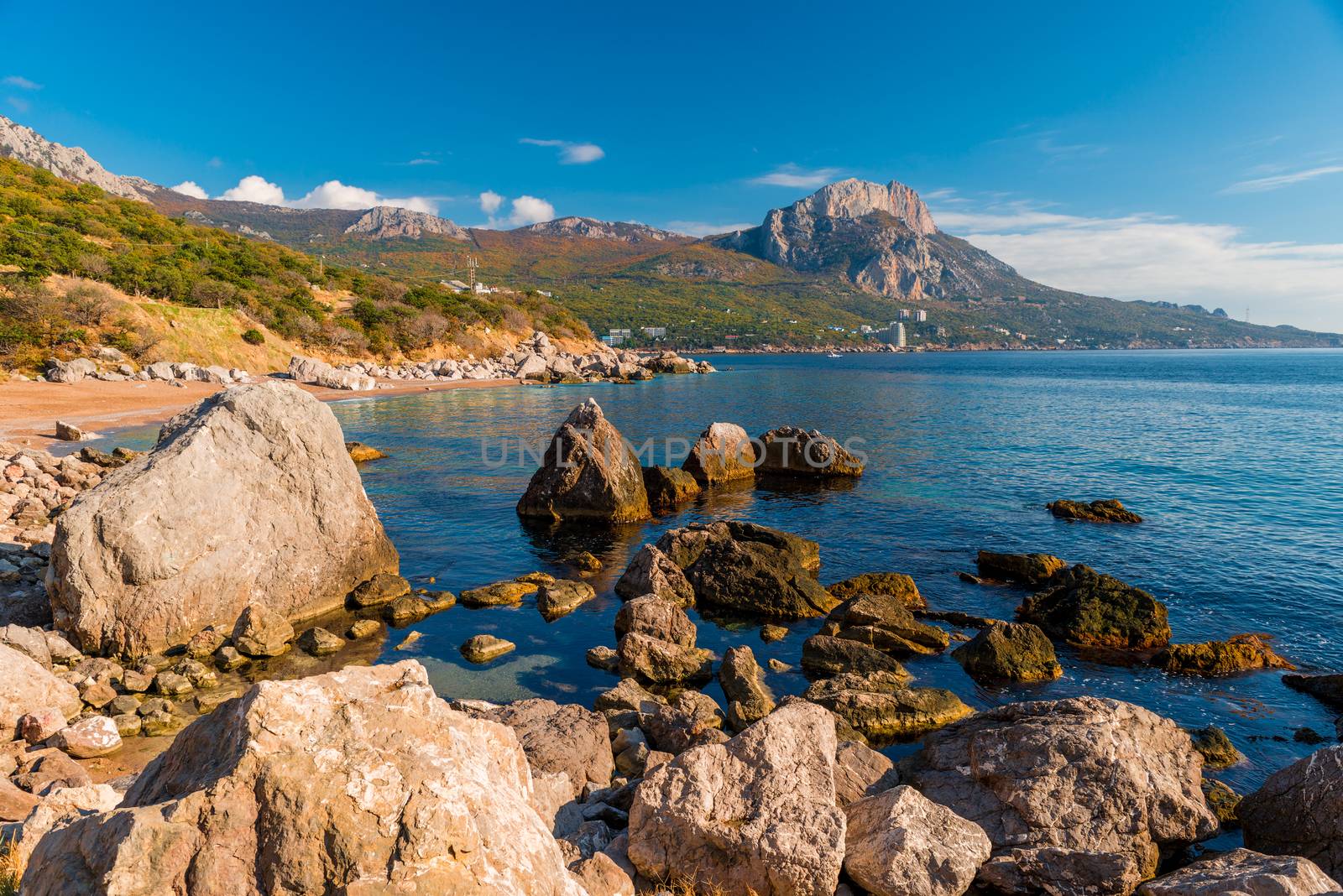 Sea shore with large boulders in the water, view of the mountain by kosmsos111