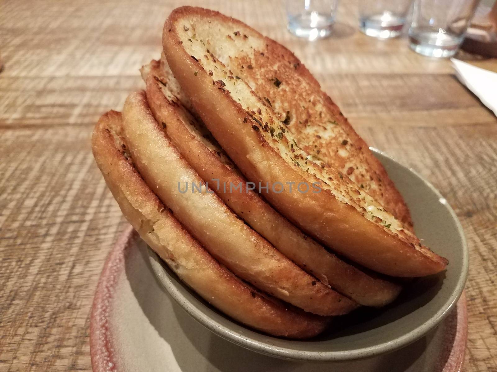 slices of seasoned garlic bread in a bowl by stockphotofan1