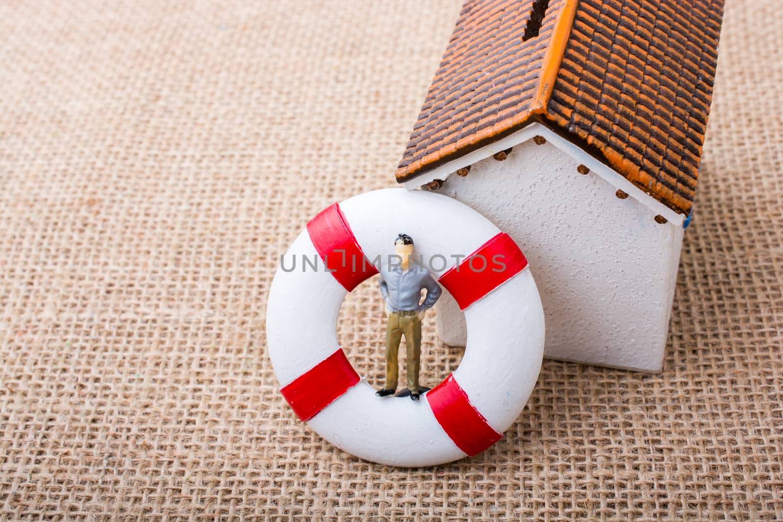 Model house and a life preserver with a man figure by berkay