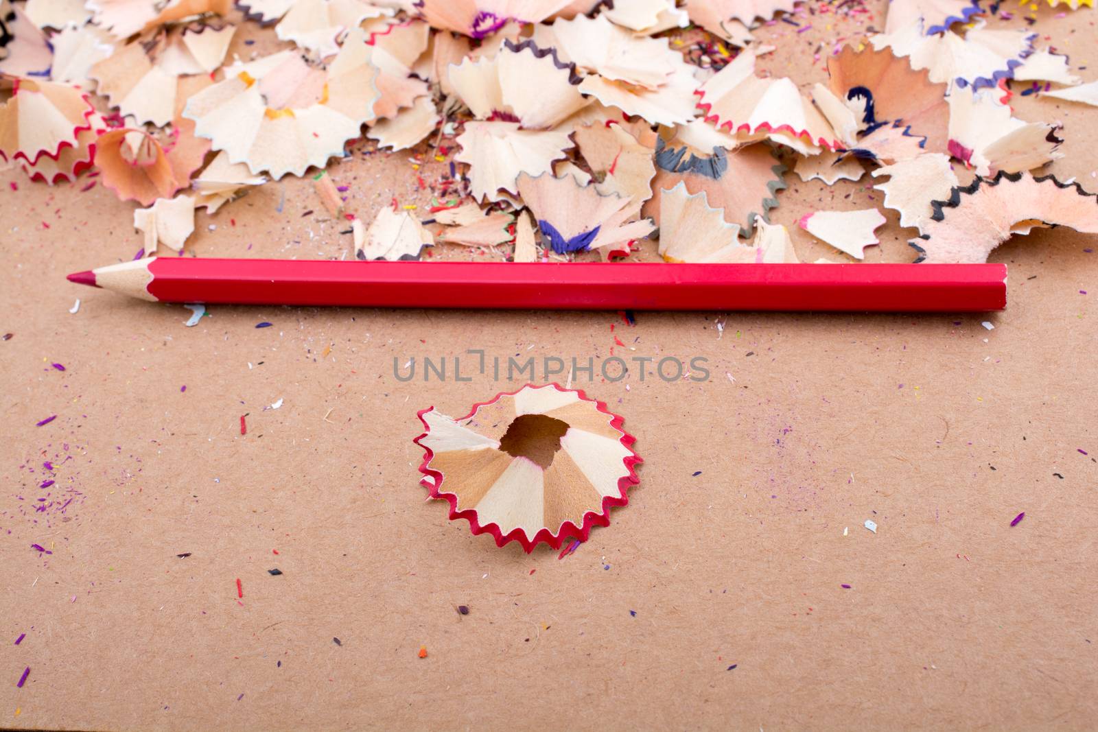 Red Color Pencil over some  pencil shavings