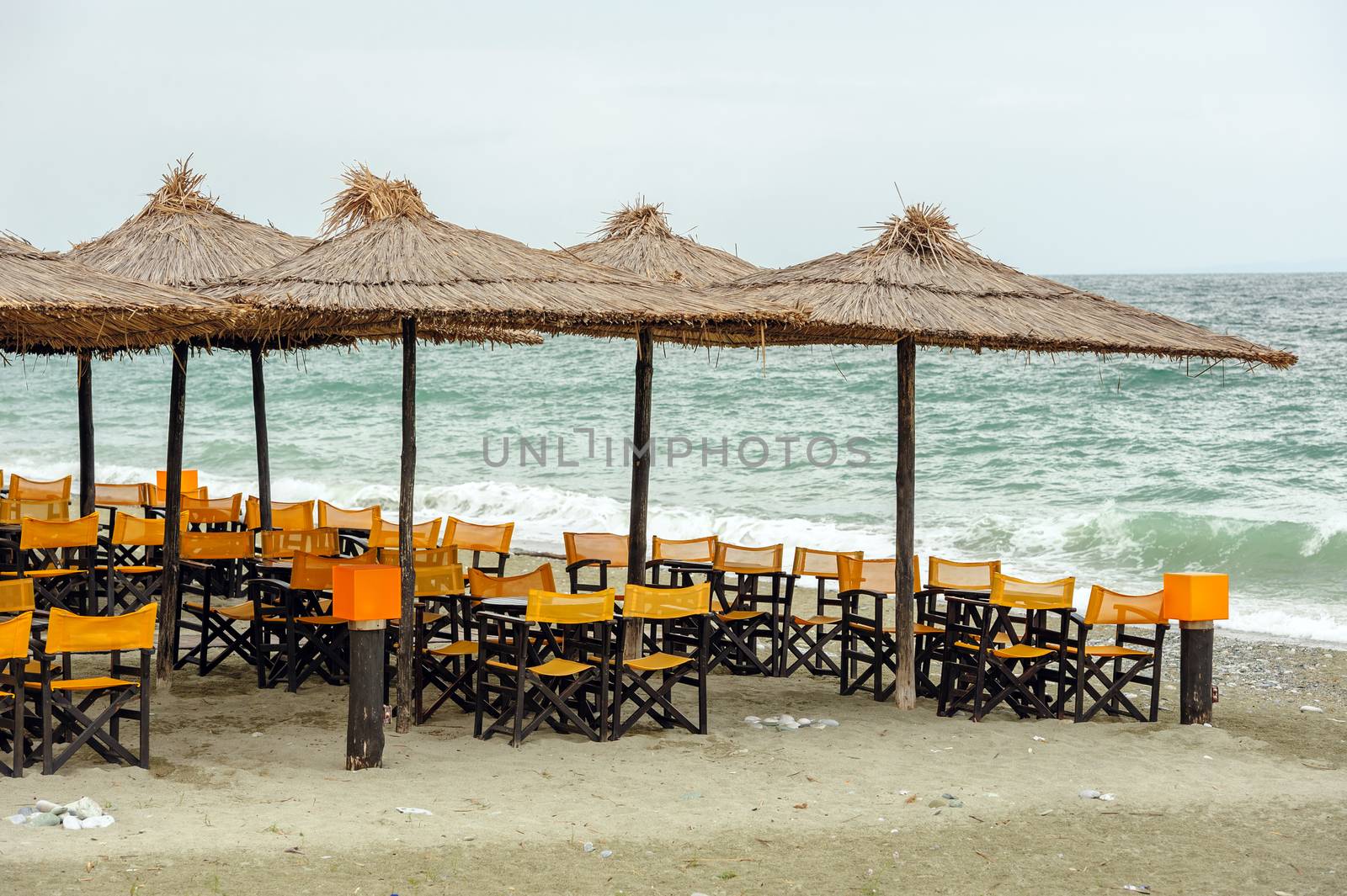 Empty beach outdoor cafe at low season with bad weather with no people. Leptokaria, Makedonia, Greece