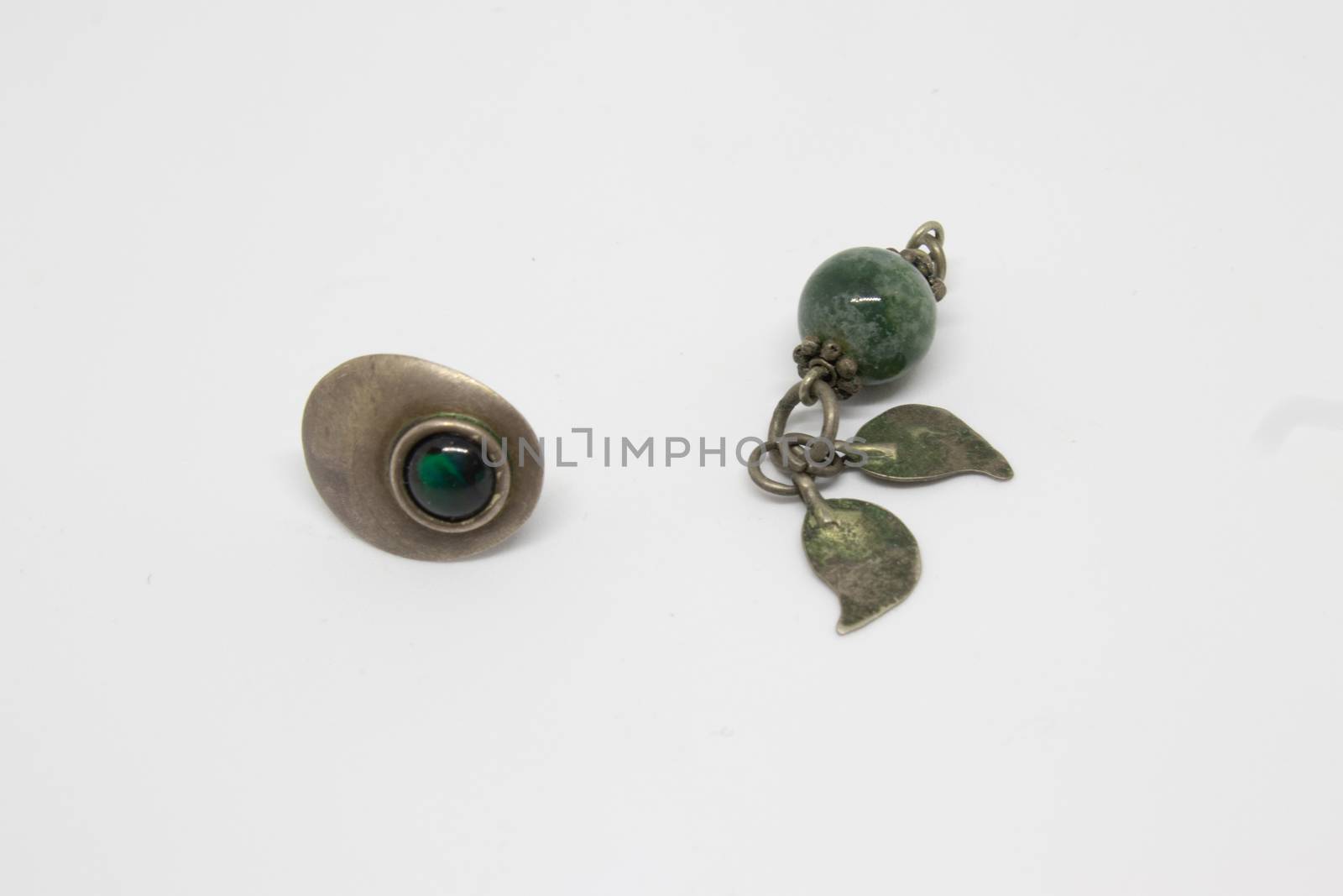 antique silver earrings with green emerald. photo has taken with photobox with white background.