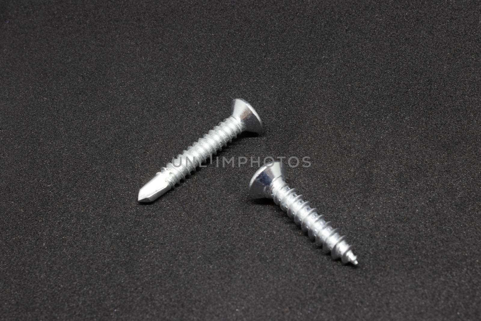 some isolated metal screw closeup shoot. photo has taken with photobox with black background.