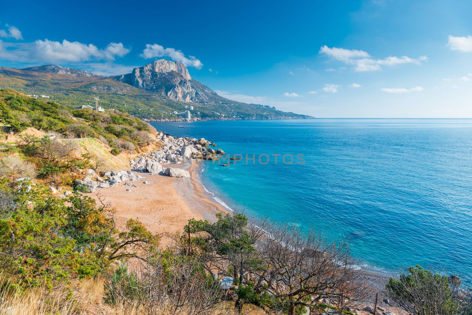 The shore of the sea, a view of a beautiful mountain and clear water on a sunny day