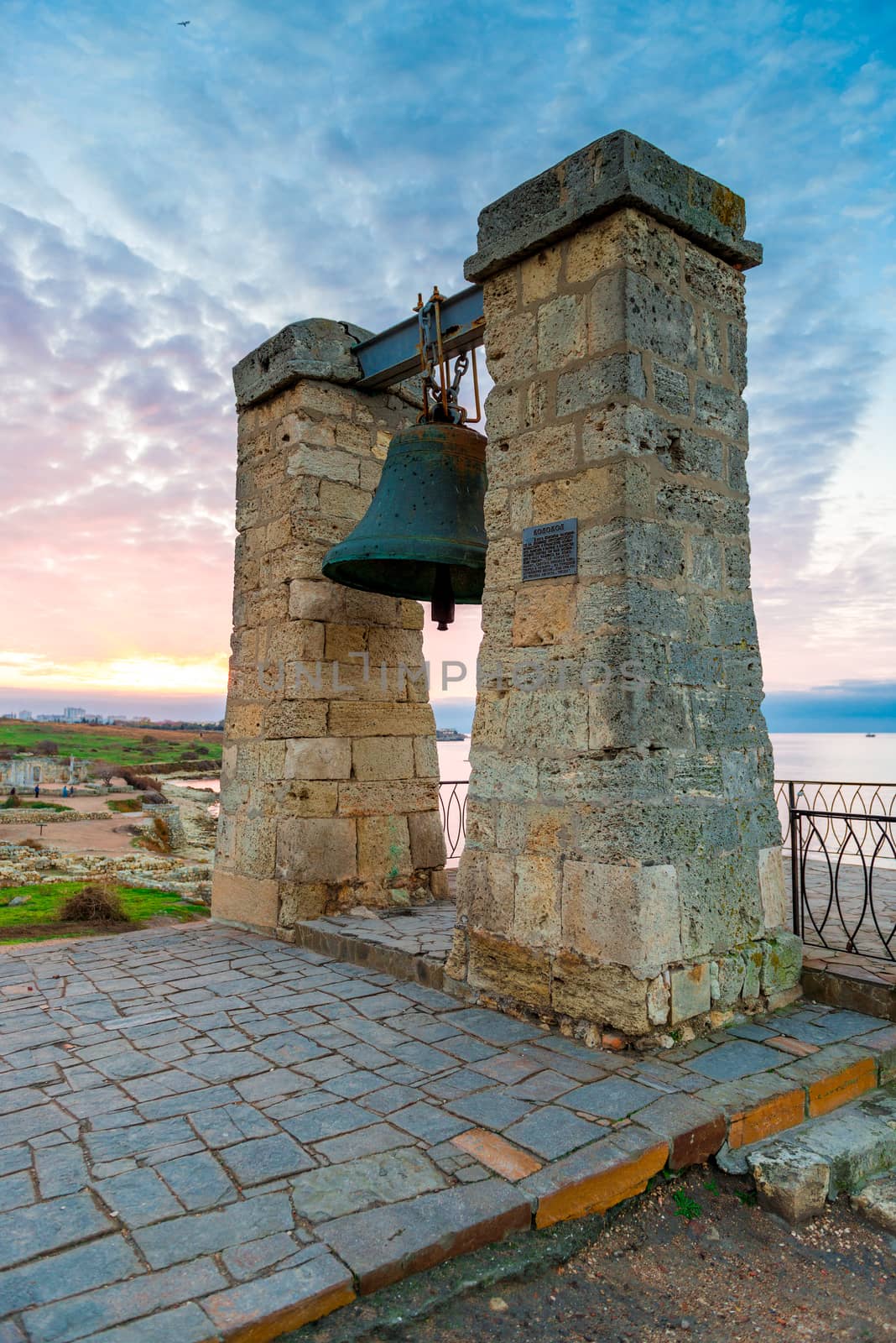 Vertical view of the big bell at sunset, Ancient Chersonese in Crimea, Russia