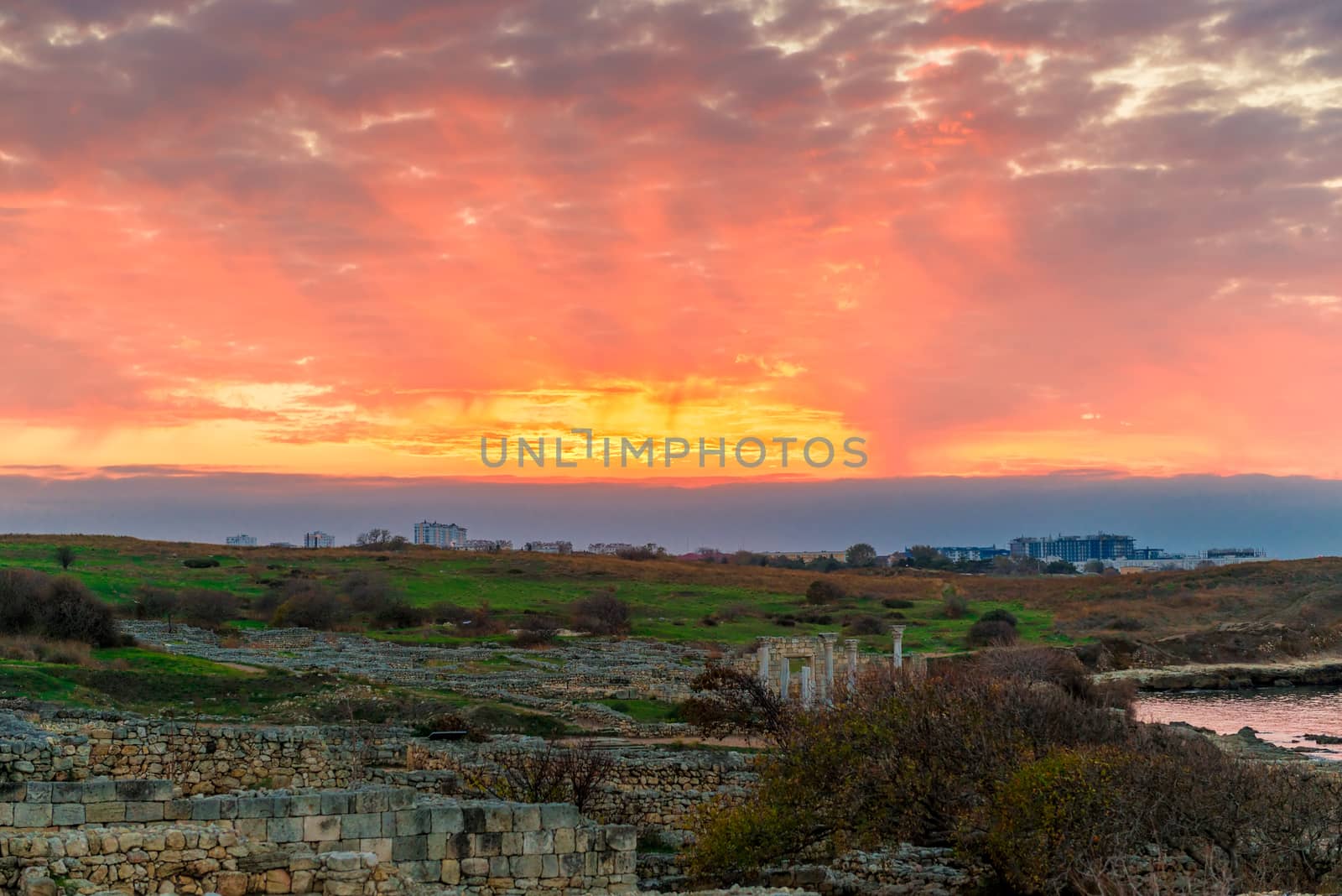 Sunset, beautiful orange sky over Ancient Chersonesos in Crimea, by kosmsos111