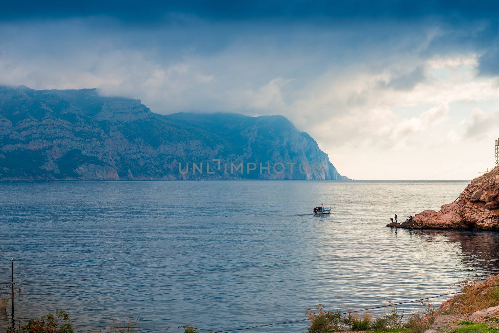 Fishing boat leaves in the sea, the sea and mountains landscape by kosmsos111