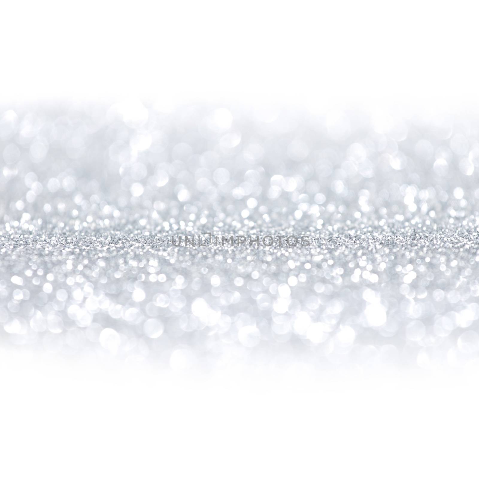 Silver festive glitter background with defocused lights