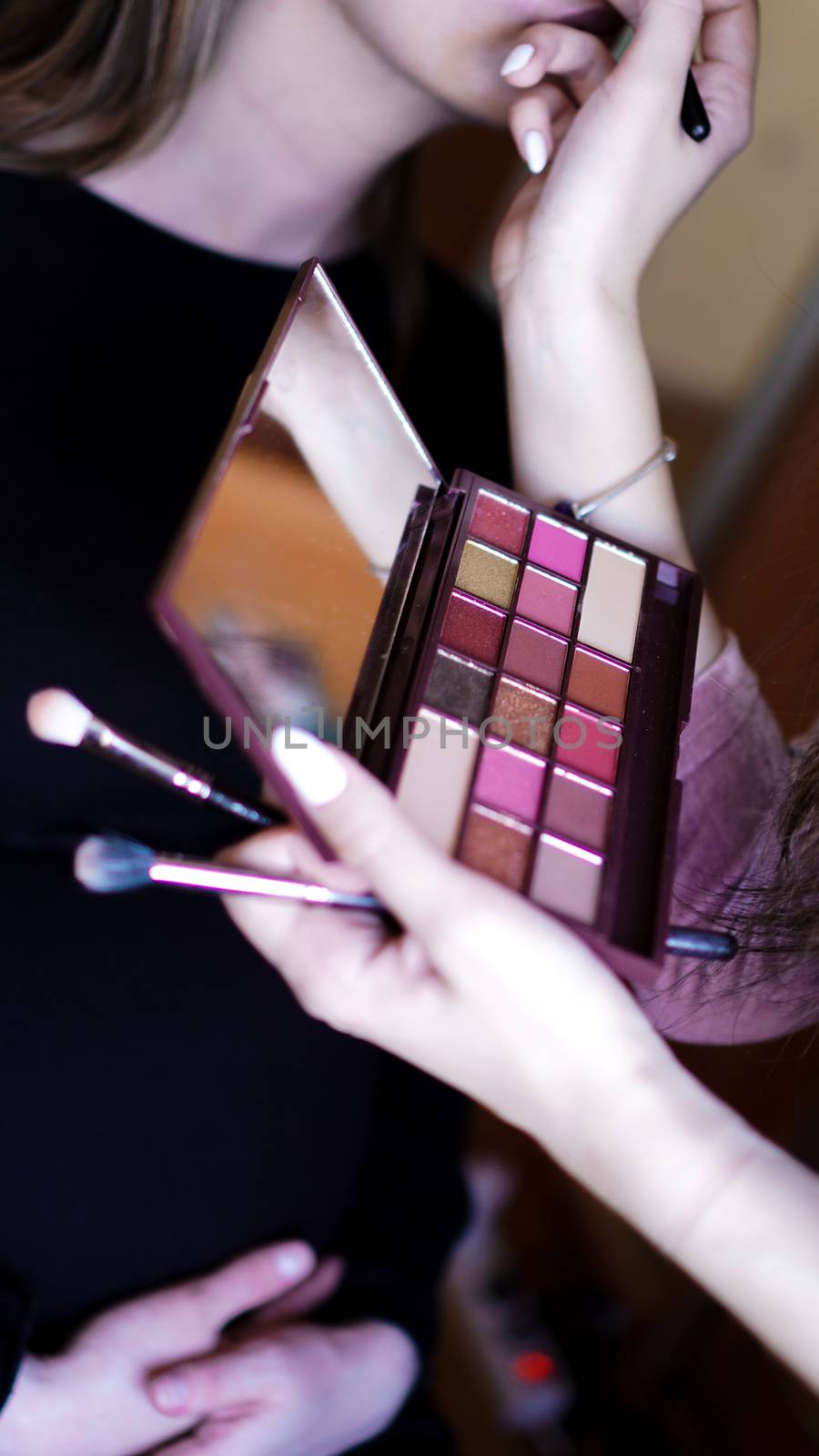 Hand use palette colorful and brush set makeup, beauty and fashion. Preparing make-up for the celebration, photo shoot