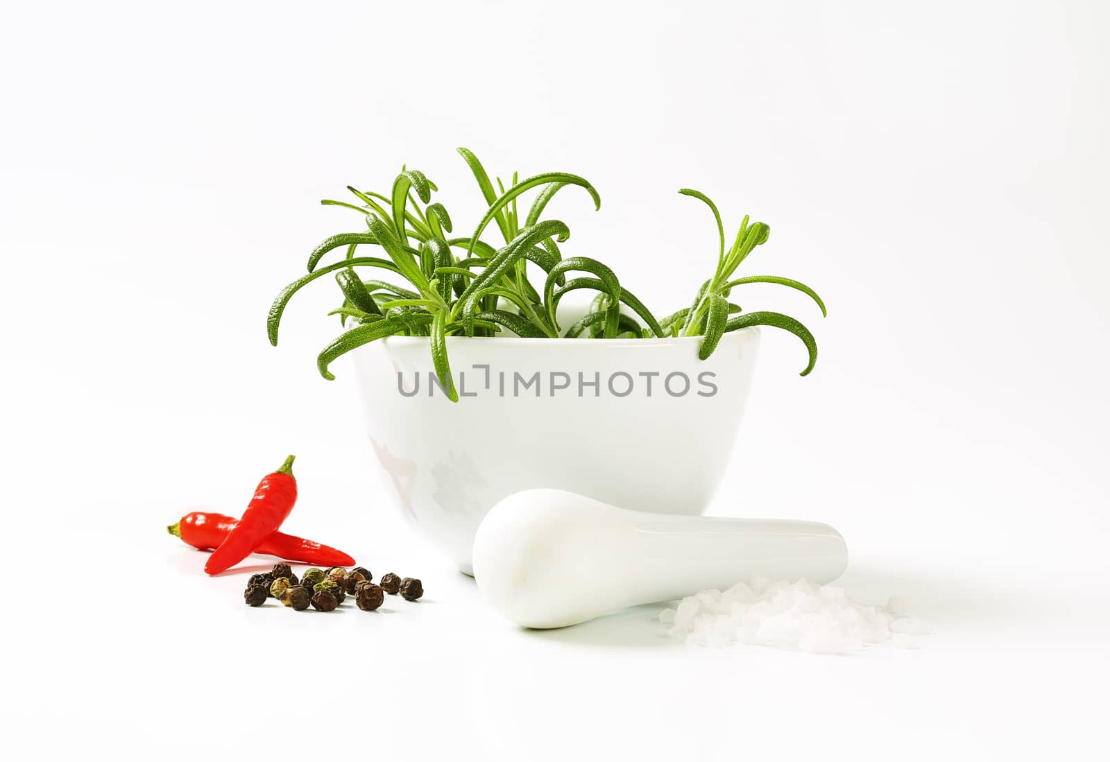 Fresh rosemary in a porcelain mortar