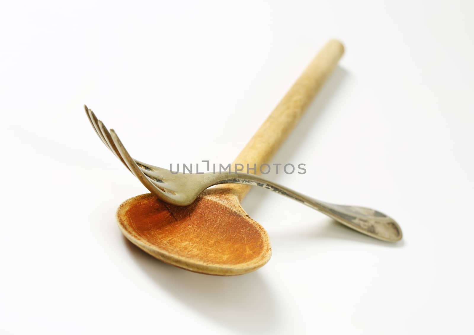 Wooden spoon and metal fork by Digifoodstock