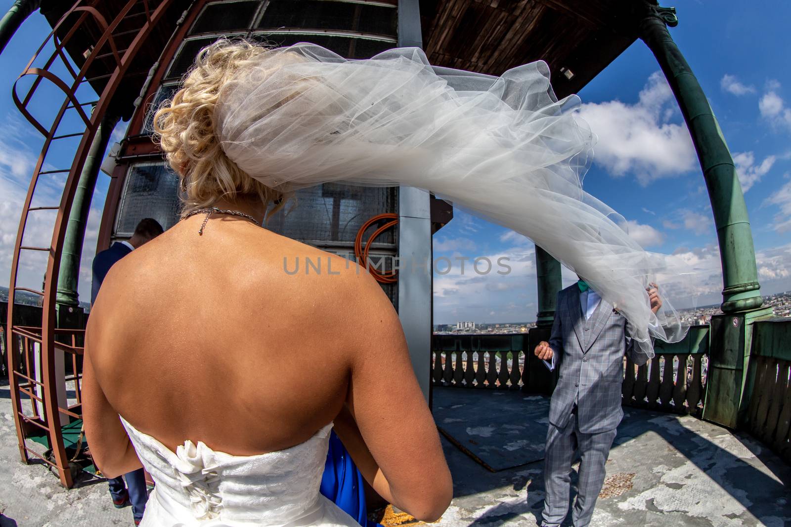 Bride with groom in church on blue sky background. by fotorobs