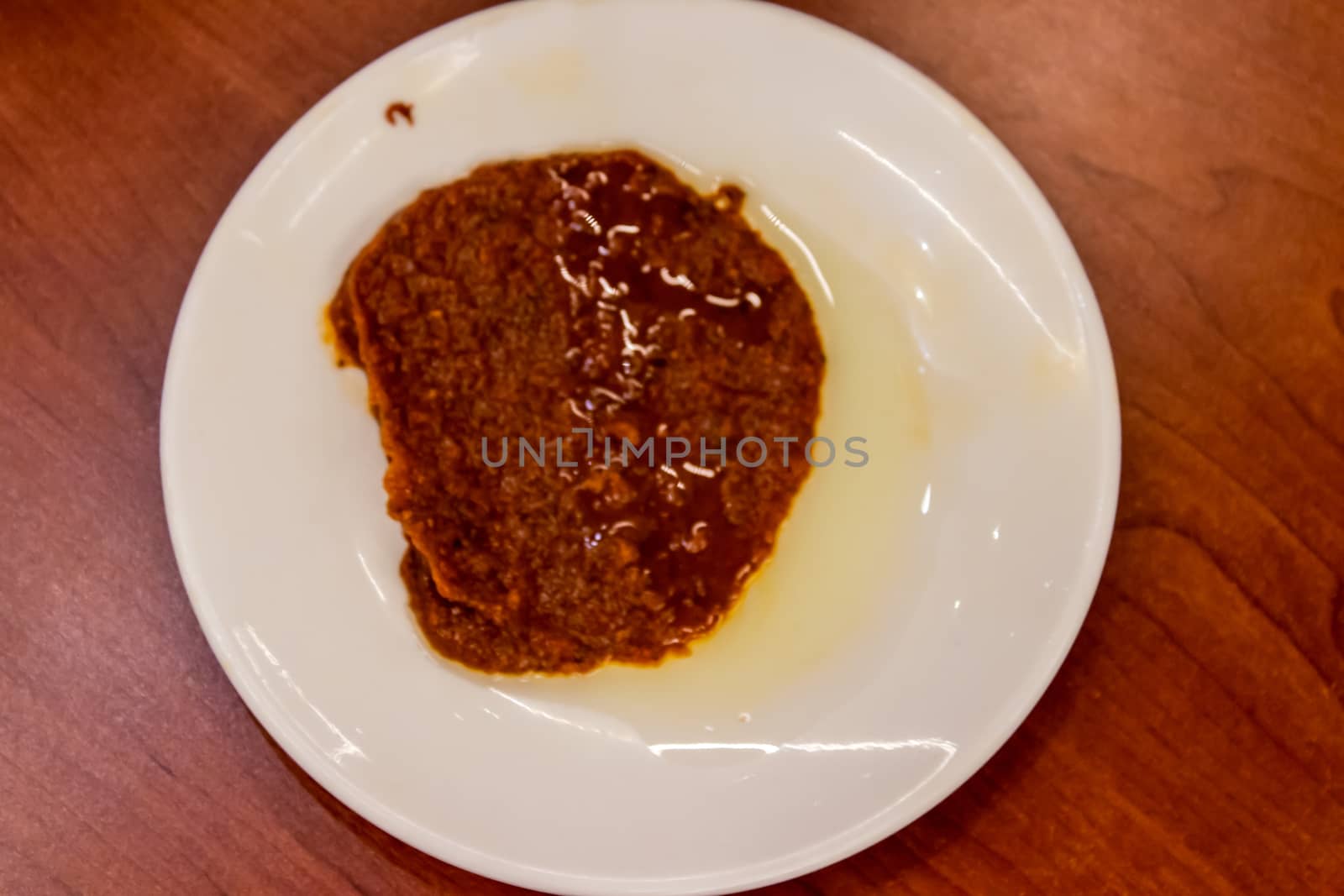 a upperview shoot to red sauce with spicy pepper with plate. closeup food shoot taken at restaurant.