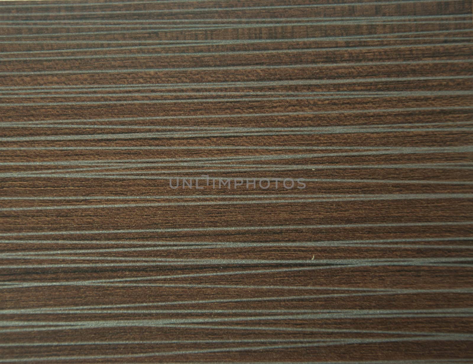 Decorative surface imitating the texture of a dark brown oak tree with silver-gray veins. Close-up