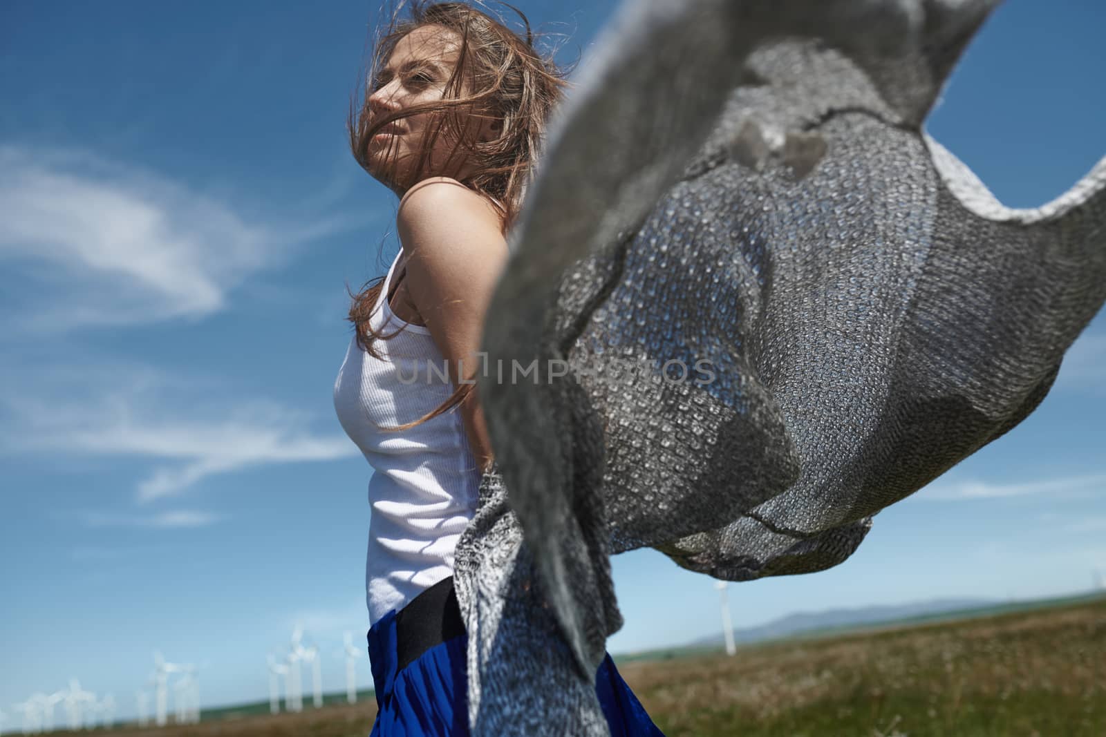 Woman with long tousled hair next to the wind turbine with the w by Novic