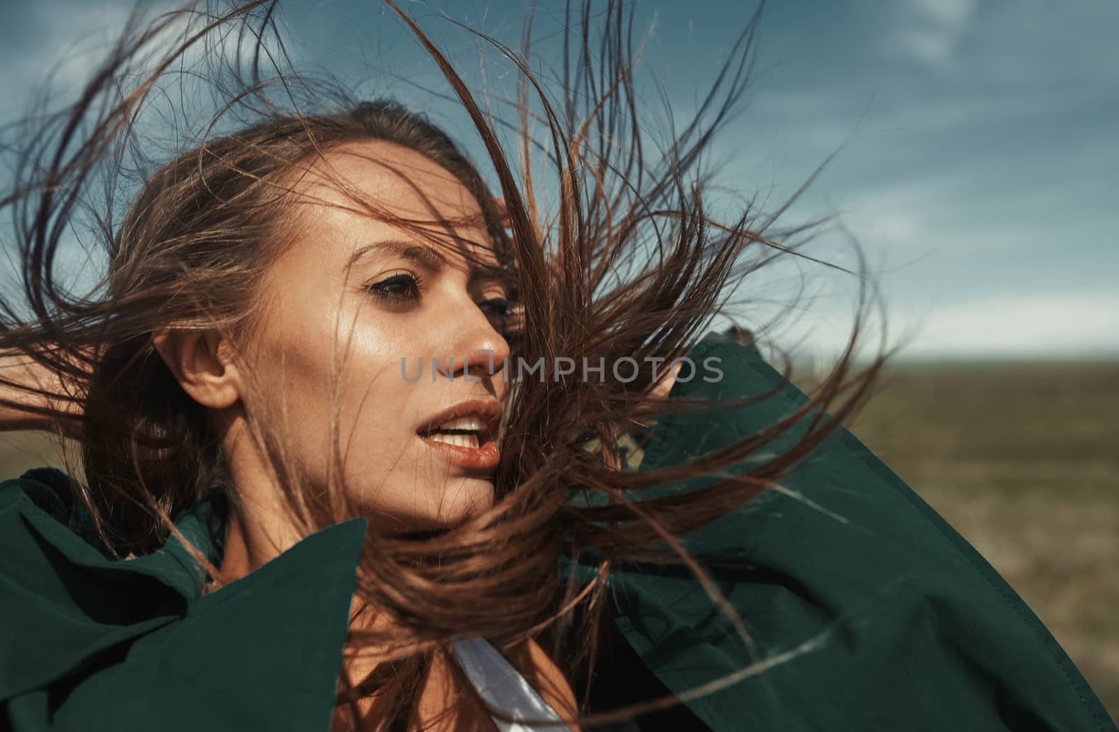 Woman outdoors with tousled wind blown hairs  by Novic