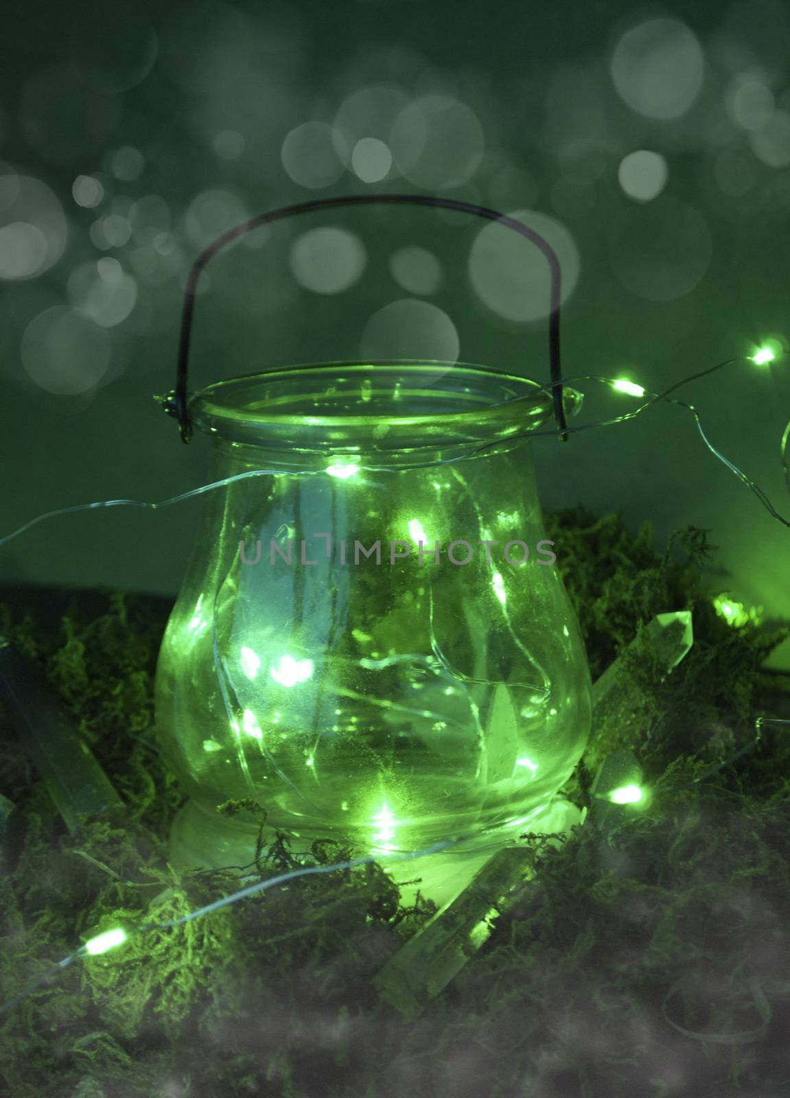 Magic cauldron on green background with moss and firefly and fog and smoke and bokeh by Izumepho
